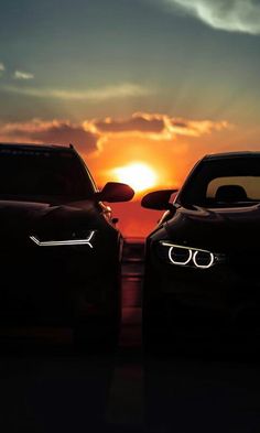 two cars parked next to each other in front of the sun