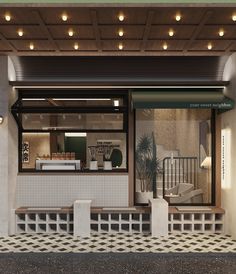 a store front with lights on the ceiling and tiled flooring in front of it