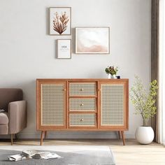 a living room with a couch, chair and sideboard