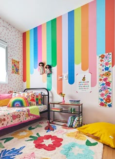 a child's bedroom decorated in rainbow colors