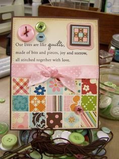 a close up of a card on a table with buttons and sewing needles in it