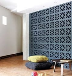 a living room with wood flooring and blue wall covering it's side area