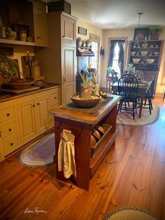 a wooden table sitting in the middle of a kitchen