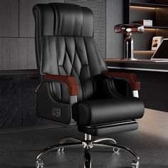 a black office chair sitting in front of a desk