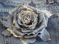 an old pair of jeans with a flower on the back of it's pocket