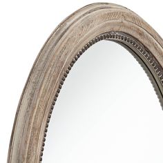 an oval wooden mirror with beading around the edges and bottom edge, on a white background