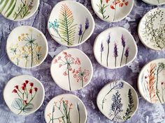 a bunch of plates that have flowers painted on them