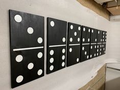 three black and white polka dots are hanging on the wall