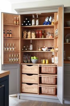 an open pantry filled with lots of food and condiments on top of wooden shelves