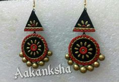 pair of red and black earrings with gold accents on white background for sale at aakansha