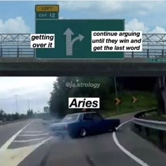 two cars driving down the road next to an overpass and another car on the street