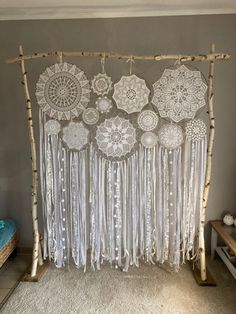 a room with white curtains and doily hanging from the ceiling