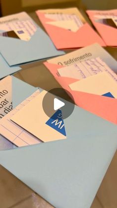 several envelopes are stacked on top of each other with different colored papers attached to them