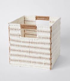 a white and brown basket with handles