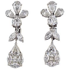 A stunning pear of earrings in a timeless design. 3.41 carats of pear, marquise, round and special cut diamonds. F/G in color VS clarity set in 18k white gold. The pear shape drop is an illusion made up of a number of special cut diamonds. The result is a fabulous rich look full of sparkle. Approximately an inch in length. Plain Gold Bangles, Earrings Multiple, Silver Cuff Bangle, Round Diamond Earrings, Open Bangle, Earrings Round, Earrings Diamond, Expensive Jewelry, Elegant Bracelet