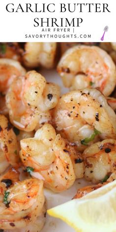 shrimp with lemon wedges on a white plate