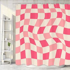 a pink and white checkered shower curtain hanging on a wall next to a ladder