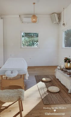 a room with a bed, table and chairs in it on the hardwood flooring