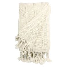 a white blanket with tassels on the bottom and one fringed off in front