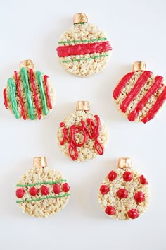 four christmas ornaments made out of rice krispy kreme and candy canes