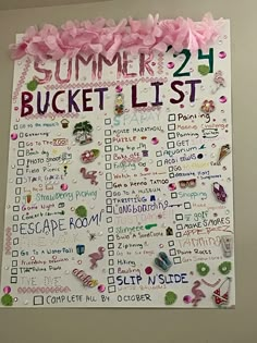 a summer bucket list hanging on the wall with pink flowers and ribbons around it's edges