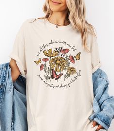 Embrace the beauty of nature with this adorable T-shirt featuring wildflowers and butterflies. The inspirational quote, "Not all those that wander are lost. Some are just searching for butterflies," adds a whimsical touch to this Comfort Colors® shirt. Perfect for nature lovers and free spirits, this tee combines a love for the outdoors with a meaningful message. Available in various sizes, it's an ideal gift for those who find joy in wandering and discovering life's little wonders. Made from soft-washed, garment-dyed fabric, this Comfort Colors®  tee offers a relaxed fit, making it an excellent daily choice. It is designed for both style and comfort. The durable double-needle stitching and pre-shrunk fabric ensure a perfect fit every time. Available in neutral and vibrant colors, this shi Wildflowers And Butterflies, Lost Quotes, Inspirational Tees, Quote Inspirational, Comfort Colors Shirt, Find Joy, Inspirational Shirt, Comfort Colors Tee, Gifts For Nature Lovers