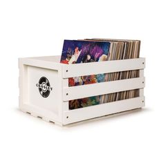 a stack of cds in a white wooden crate on a white background with the lid open