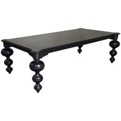 a black table with three balls on the legs and a wooden top, against a white background