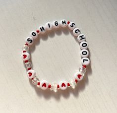 a bracelet with red and white beads that spell out the word sch8hschool