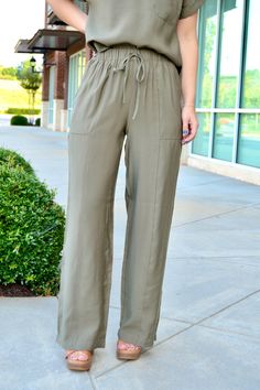 Olive high waist drawstring straight leg pants with side and back pockets Sizes S, M and L Fabric: 85% rayon, 15% polyester Chic Relaxed Fit Pants With Drawstring, Loungewear Bottoms With Tie Waist And Straight Leg, Spring Cargo Pants With Elastic Waistband And Straight Leg, Versatile Wide-leg Pants With Tie Waist, Casual Rayon Bottoms For Fall, Relaxed Fit Tapered Leg Bottoms With Tie Waist, High-waisted Pants With Side Pockets For Day Out, Drawstring Trousers For Day Out, Summer Wide Leg Pants With Drawstring For Work