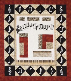 a quilted wall hanging with musical notes and trellographs on the border