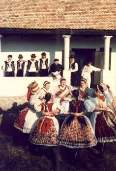 a group of people standing in front of a building