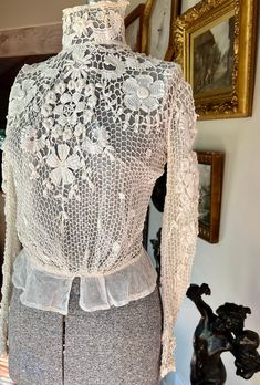 "This is an incredibly lovely hand crocheted blouse purchased from a sale by the Monterey Museum. It dates to the Belle Epoque or Edwardian era and is as wearable today as it was then. The ivory colored crochet has an inner layer of fine netting and it has little hook and eye closures at the back. Size is small or extra small with bust 36\", waist23\", armholes16\", and it is 16\" across the shoulders with 22\" long sleeves and measuring 17\" long from shoulder to beginning of peplum. The blouse Elegant Fitted Lace Top With Crochet Trim, Vintage White Crochet Lace Top, Vintage White Top With Crochet Lace, Vintage White Tops With Crochet Lace, Vintage Cream Crochet Top, Spring Vintage Crochet Top With Lace Work, Vintage White Lace Crochet Top, White Vintage Lace Crochet Top, Spring Vintage Lace Crochet Top