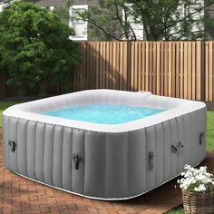 an inflatable hot tub sitting on top of a brick patio