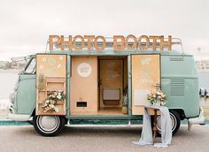 an old vw bus converted into a wedding photo booth with flowers on the door