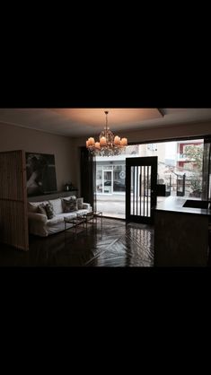 a living room filled with furniture and a chandelier