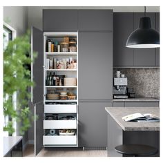 a kitchen with gray cabinets and white drawers