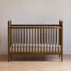 a baby crib in front of a white wall