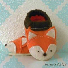 a pair of baby shoes made to look like a fox