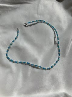 This necklace is made of blue seed beads and small pearls with a clasp. The beads are small for a cute minimalist look while still having a sophisticated and preppy look. They really fit in with the outer banks style which is so trendy at the moment! It can be styled with so many pieces to make any outfit really cute and trendy. This vsco style is so popular at the moment and this necklace is the perfect fit for that! Something that kiara from outer banks might wear! Gift for him, gift for her p Blue Tiny Beads Choker For Summer, Blue Beaded Choker For Summer, Trendy Blue Choker With Colorful Beads, Trendy Blue Choker With Tiny Beads, Summer Blue Beaded Choker, Casual Blue Beaded Choker, Blue Single Strand Beaded Necklace For Summer, Casual Blue Choker With Colorful Beads, Trendy Blue Beaded Choker