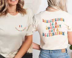 two women wearing t - shirts that say breastfeeding is a journey not a destination