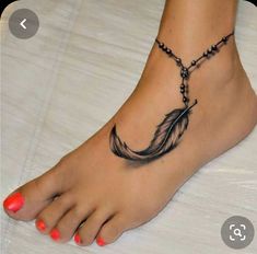 a woman's foot with a feather tattoo on it