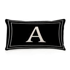 a black and white pillow with the letter a on it