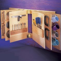 an open tool box with tools in it on a purple tablecloth and blue background