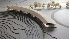 an architectural model of a building with trees in the background