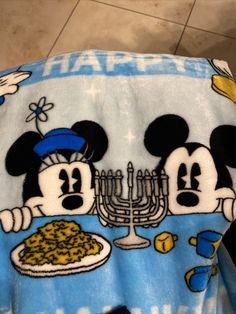 a mickey mouse towel with some food on it