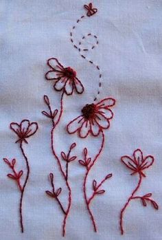 embroidered flowers on white linen with red thread