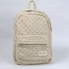 Our Nude Backpack is a charming and stylish bag designed to carry all your essentials with a timeless flair.   The quilted exterior boasts a beautiful beige gingham pattern, complemented by the matching beige interior crafted from thick and soft terry material.  Designed for practicality, this backpack features a convenient exterior pocket for easy access to your essentials on the go. Inside, discover another dedicated pocket for added organization, ensuring that your belongings are always at yo Beige Gingham, Mini Makeup Bag, Coastal White, Aesthetic Backpack, Unique Backpacks, Large Makeup Bag, Beige Interior, Vanity Bag, College Stuff