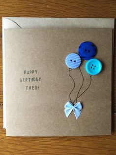 a birthday card with two buttons attached to it