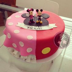 a birthday cake with minnie and mickey mouse on it